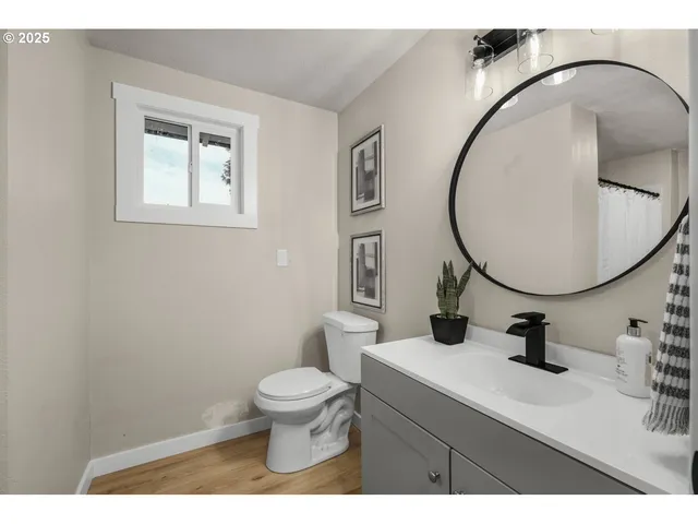 a bathroom with a sink mirror and toilet