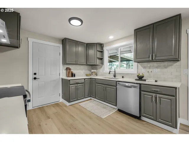 a kitchen with a sink cabinets and window