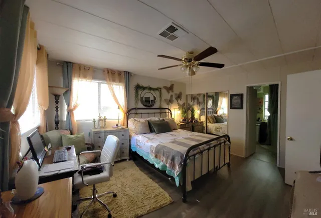 a bedroom with a bed a couch and dresser