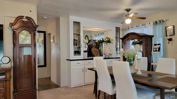 a view of a dining room with furniture and chandelier