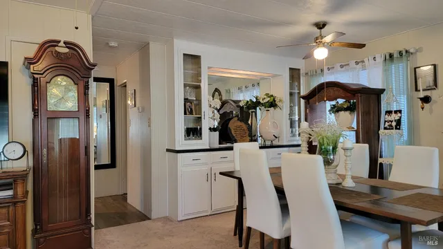 a view of a dining room with furniture and chandelier