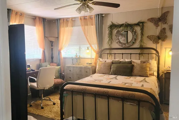 a bedroom with a bed and a window