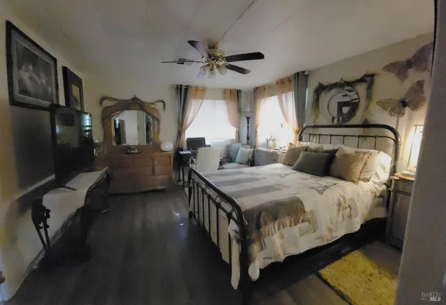 a bedroom with a bed next to a window with the outer view