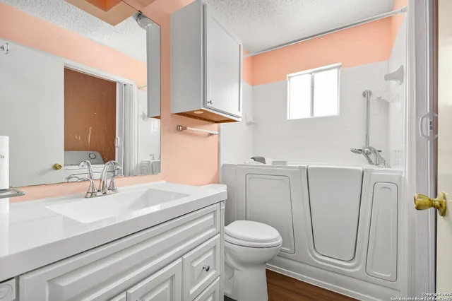 a bathroom with a sink a toilet and a mirror