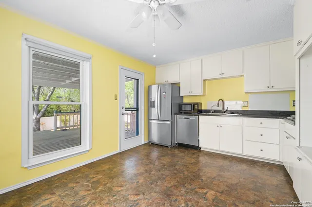 a kitchen with stainless steel appliances a refrigerator sink and cabinets