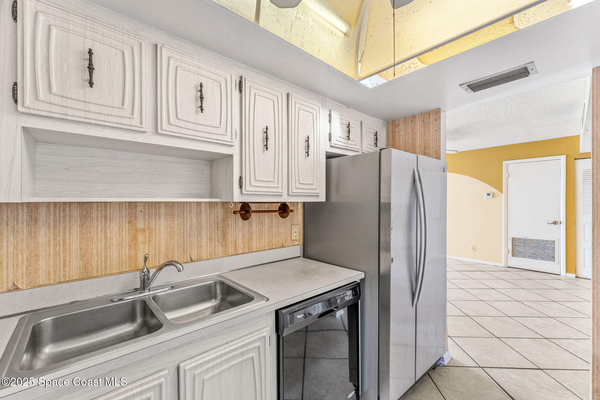 877 N Highway, Unit 904 Indialantic, FL 32903 - Photo 10 of 42 a kitchen with stainless steel appliances granite countertop a refrigerator and a sink