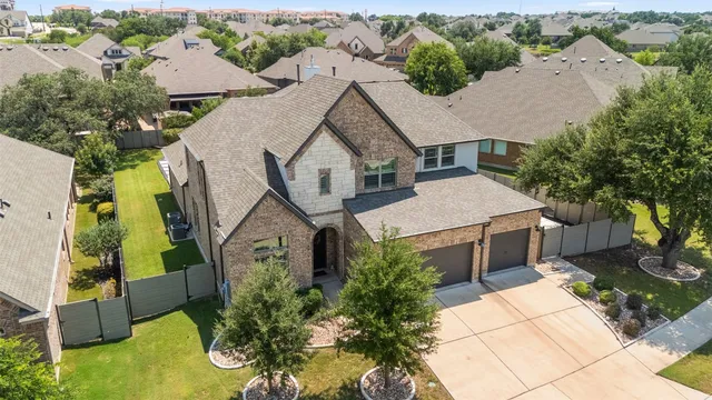 an aerial view of a house with a yard and potted plants