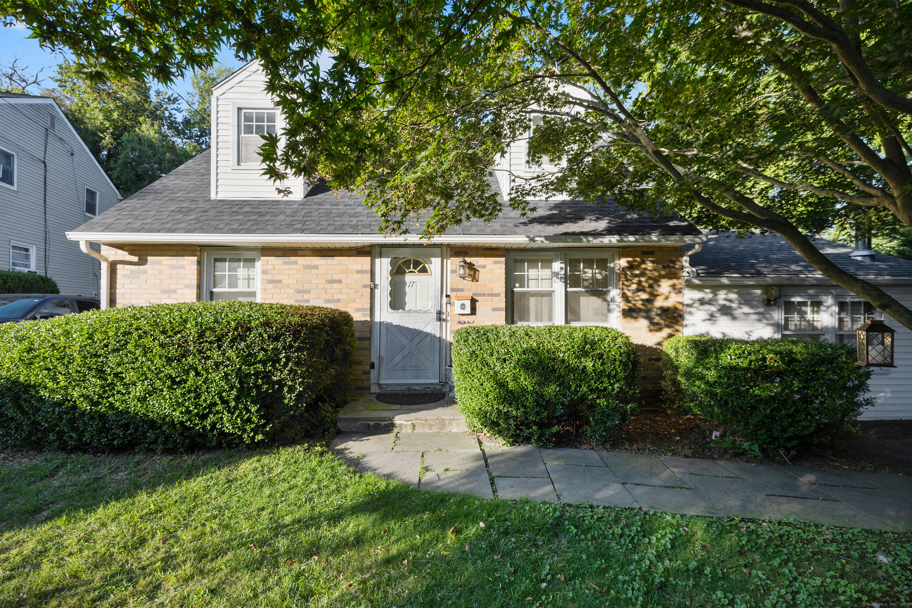 Desirable curb appeal with nice lawn and mature plantings.