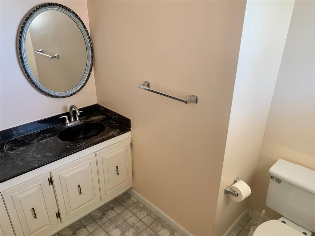 1710 Northeast 191st Street, Unit 4123 Miami, FL 33179 - Photo 15 of 17 a bathroom with a sink a toilet and a mirror