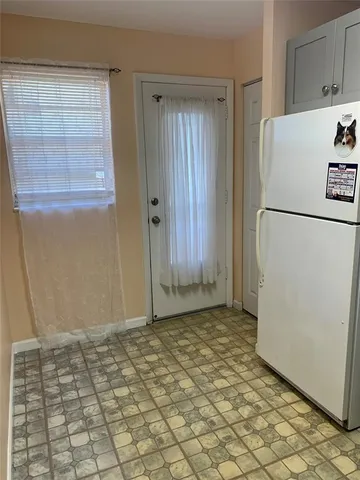 a view of a refrigerator in kitchen and wooden floor