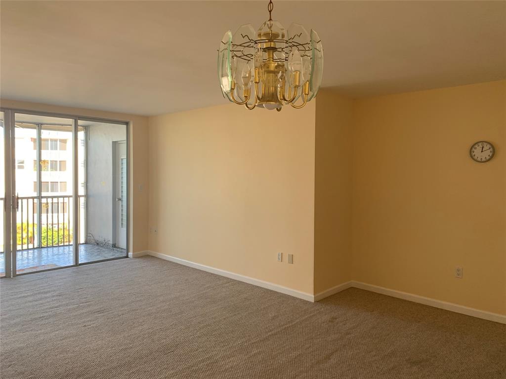 1710 Northeast 191st Street, Unit 4123 Miami, FL 33179 - Photo 6 of 17 an empty room with windows