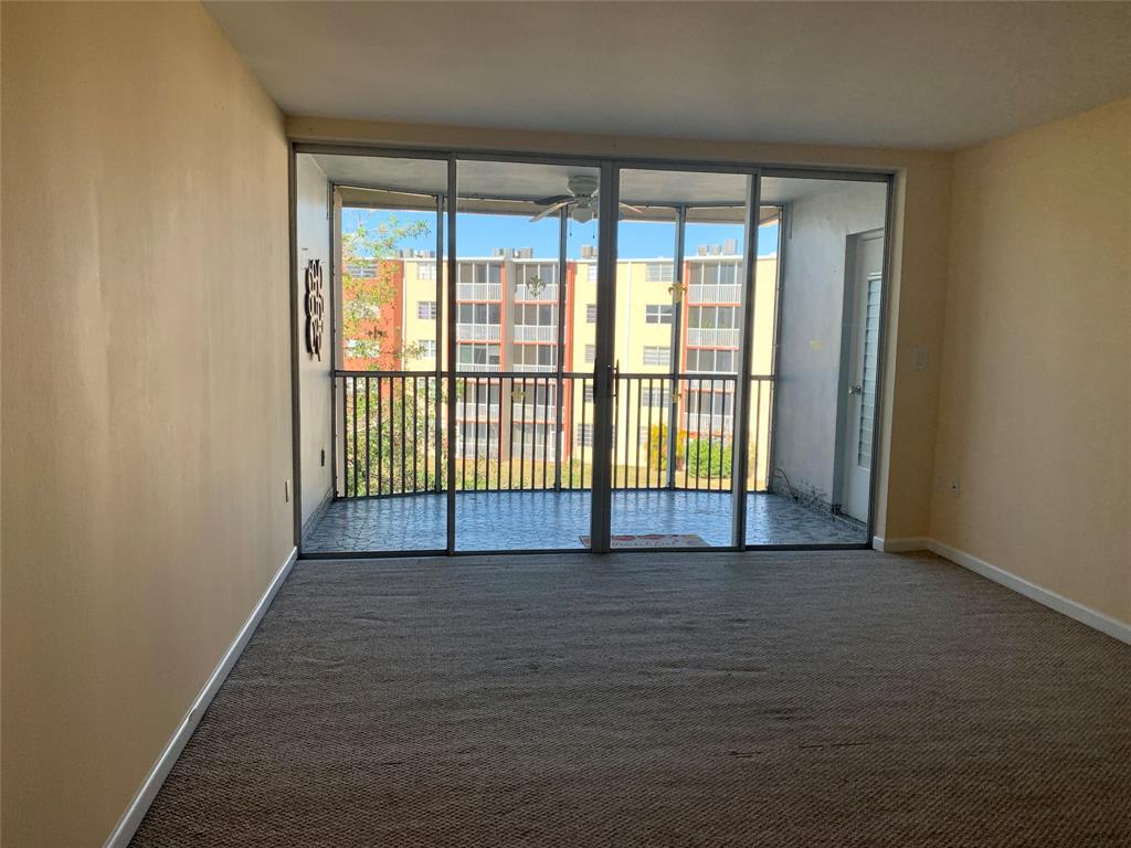 1710 Northeast 191st Street, Unit 4123 Miami, FL 33179 - Photo 8 of 17 a view of a big room with wooden floor and windows