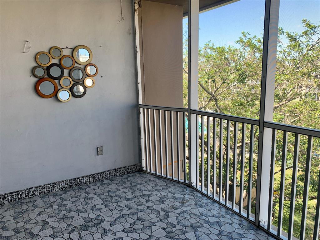 1710 Northeast 191st Street, Unit 4123 Miami, FL 33179 - Photo 9 of 17 a view of a porch with a bench