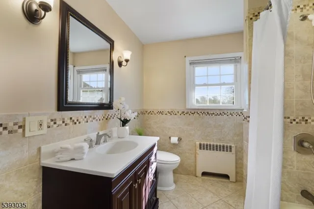 a bathroom with a sink a toilet and mirror