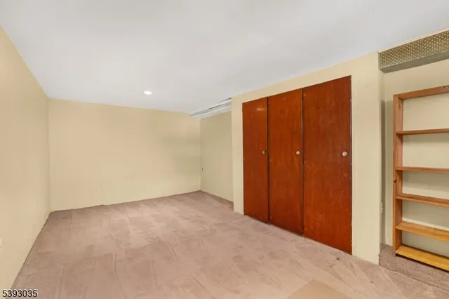 an empty room with closet area
