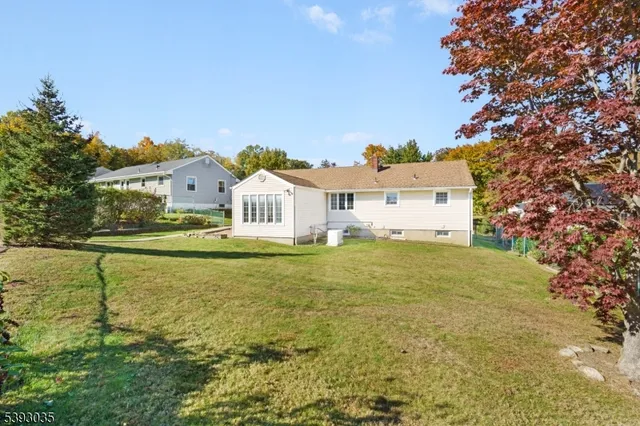 a house view with swimming pool in front of it
