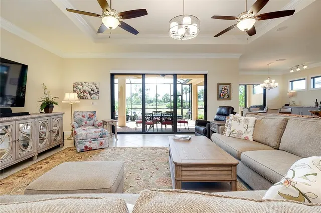 a view of a dining room with furniture a chandelier and wooden floor