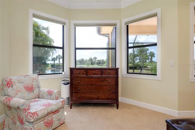 a view of a dining room with furniture large windows and wooden floor