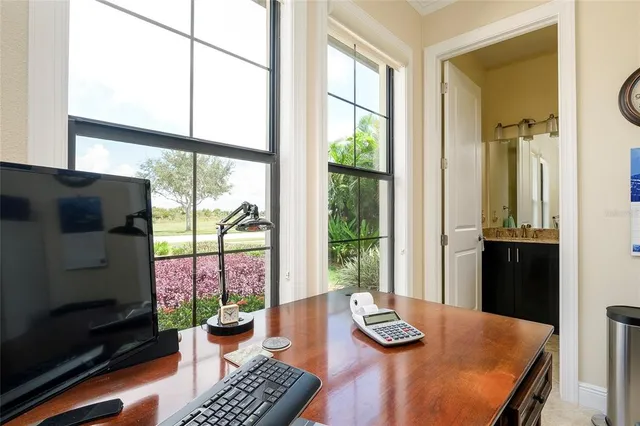 an aerial view of residential houses with outdoor space and lake view