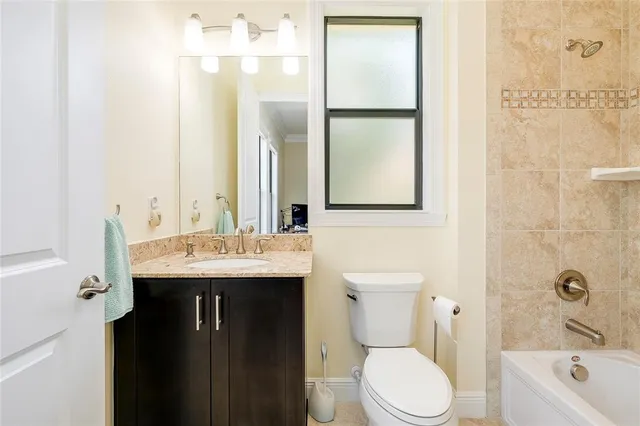 an aerial view of a house with a garden and lake view