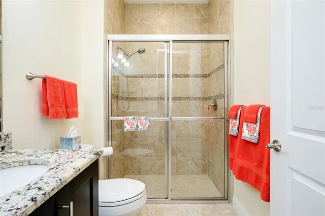 a view of a white house with a big yard and palm trees