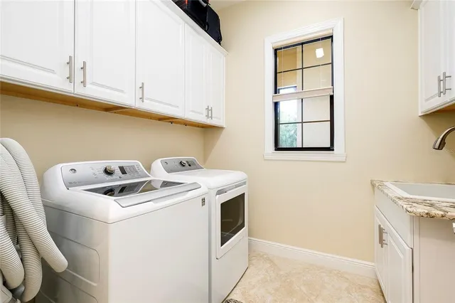 front view of house with a yard and palm trees
