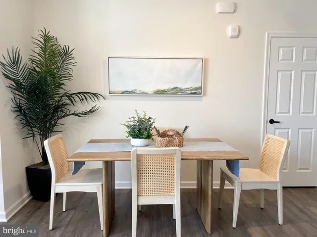 a dining room with furniture and wooden floor