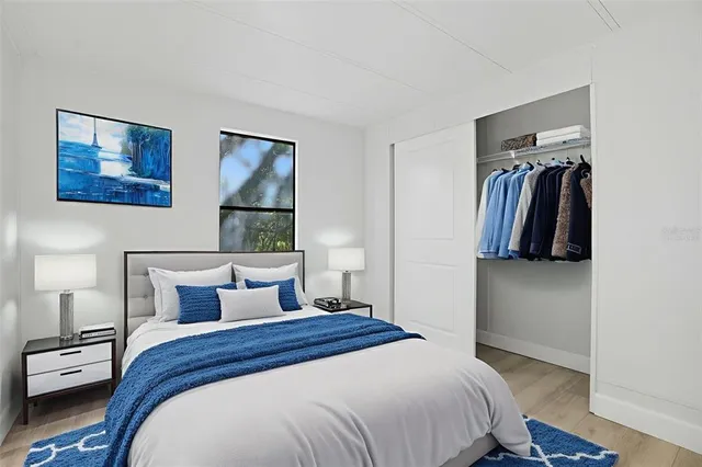 a bedroom with a bed and a painting on the wall