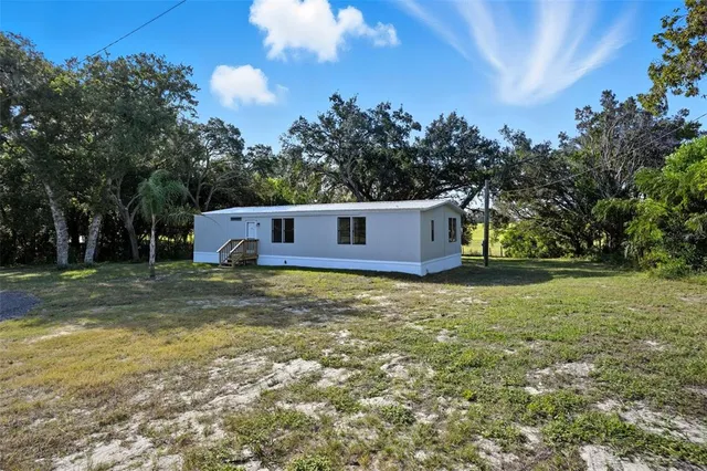 an aerial view of a houses with a yard