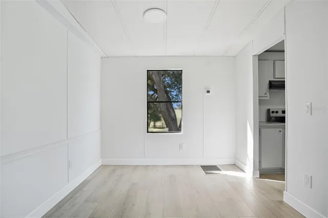 an empty room with windows and closet