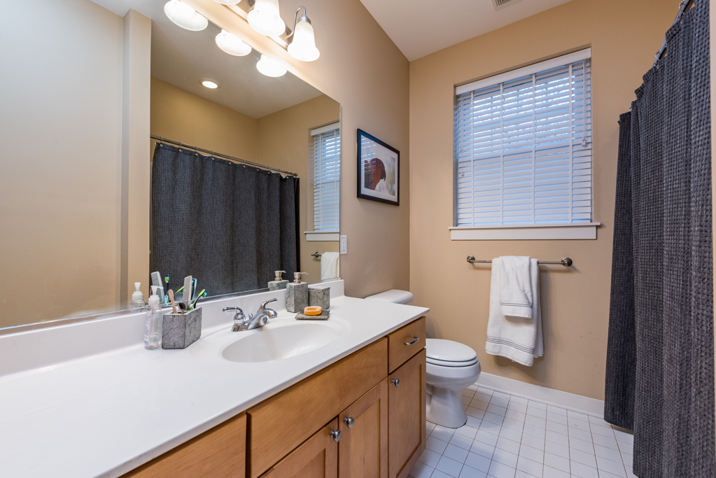 1004 Harris Road Grayslake, IL 60030 - Photo 16 of 24 a bathroom with a sink a toilet and a large mirror