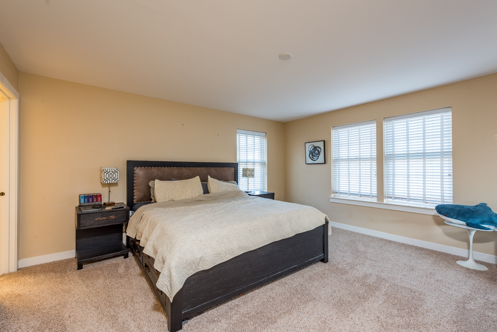 1004 Harris Road Grayslake, IL 60030 - Photo 10 of 24 a spacious bedroom with a bed and a couch
