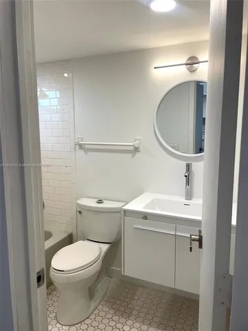 a bathroom with a sink a toilet and vanity