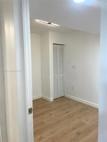 an empty room with wooden floor