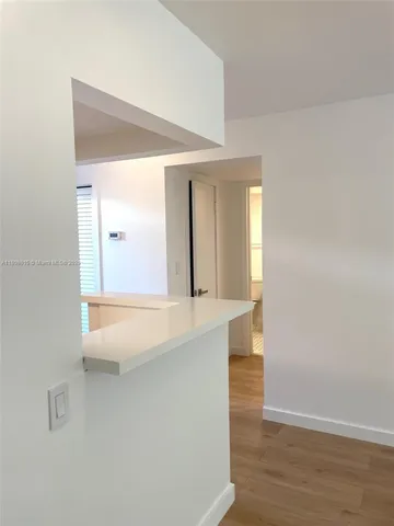 a view of a bathroom from a hallway