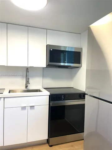 a kitchen with a stove and a microwave
