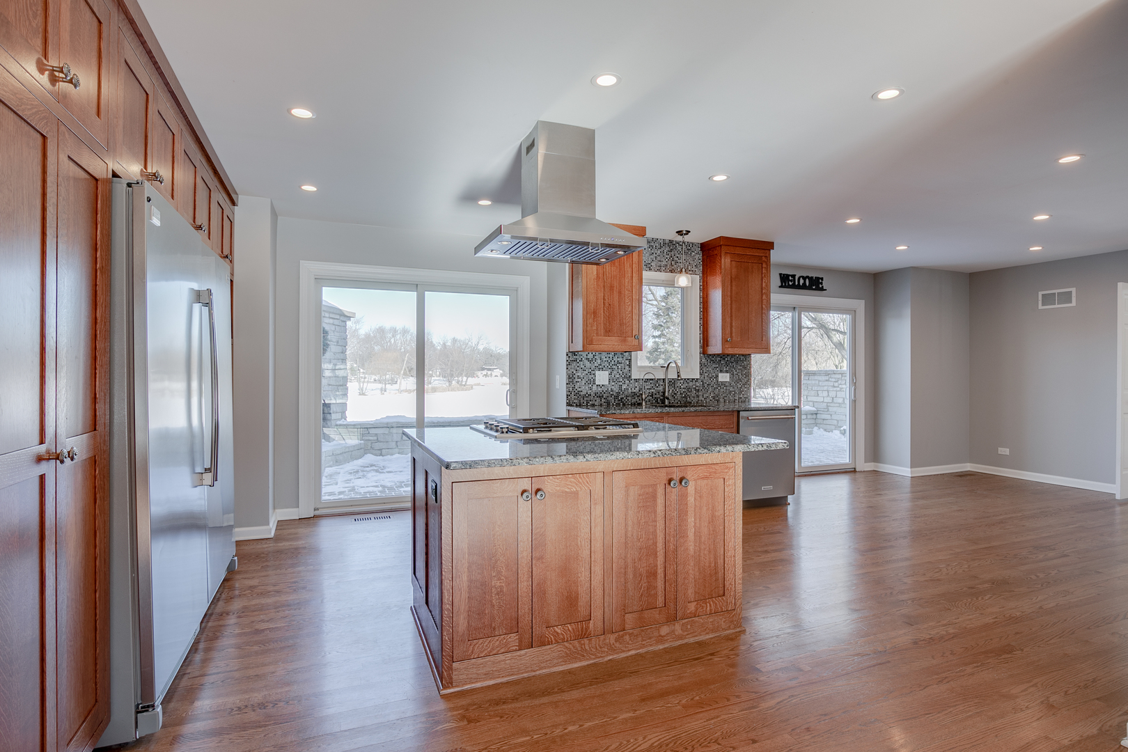21242 West Long Grove Road Kildeer, IL 60047 - Photo 12 of 42 a kitchen with stainless steel appliances granite countertop a refrigerator a stove and a wooden floors