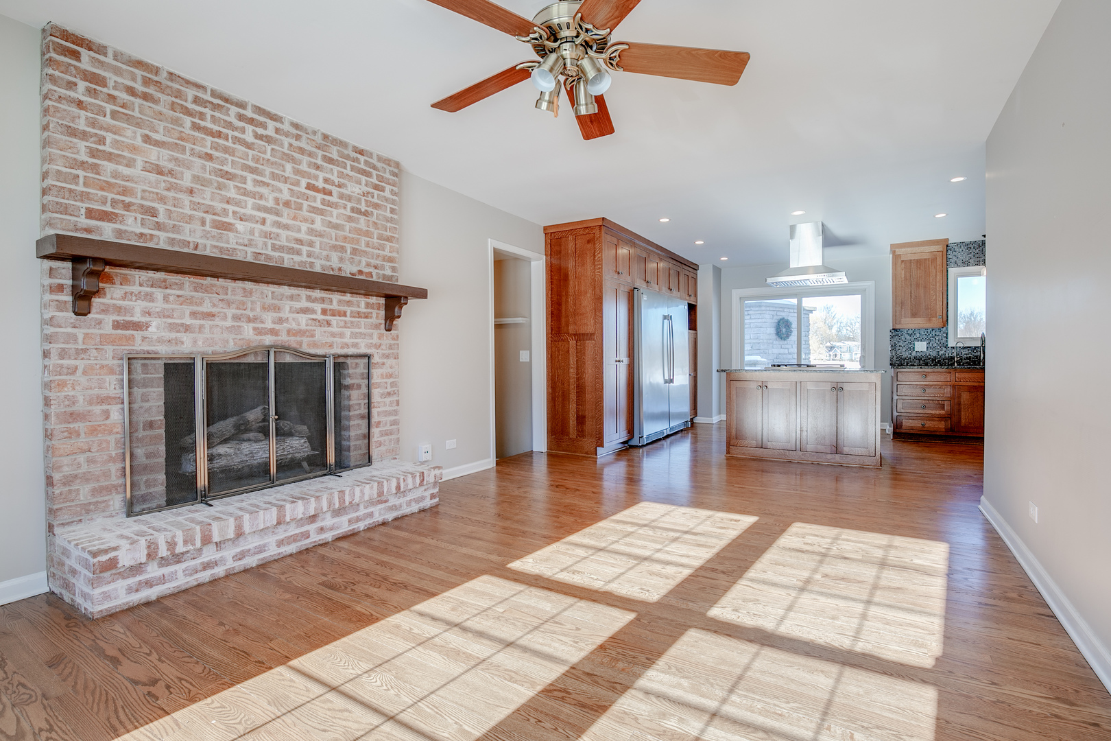 21242 West Long Grove Road Kildeer, IL 60047 - Photo 15 of 42 a hallway with a fireplace and a chandelier