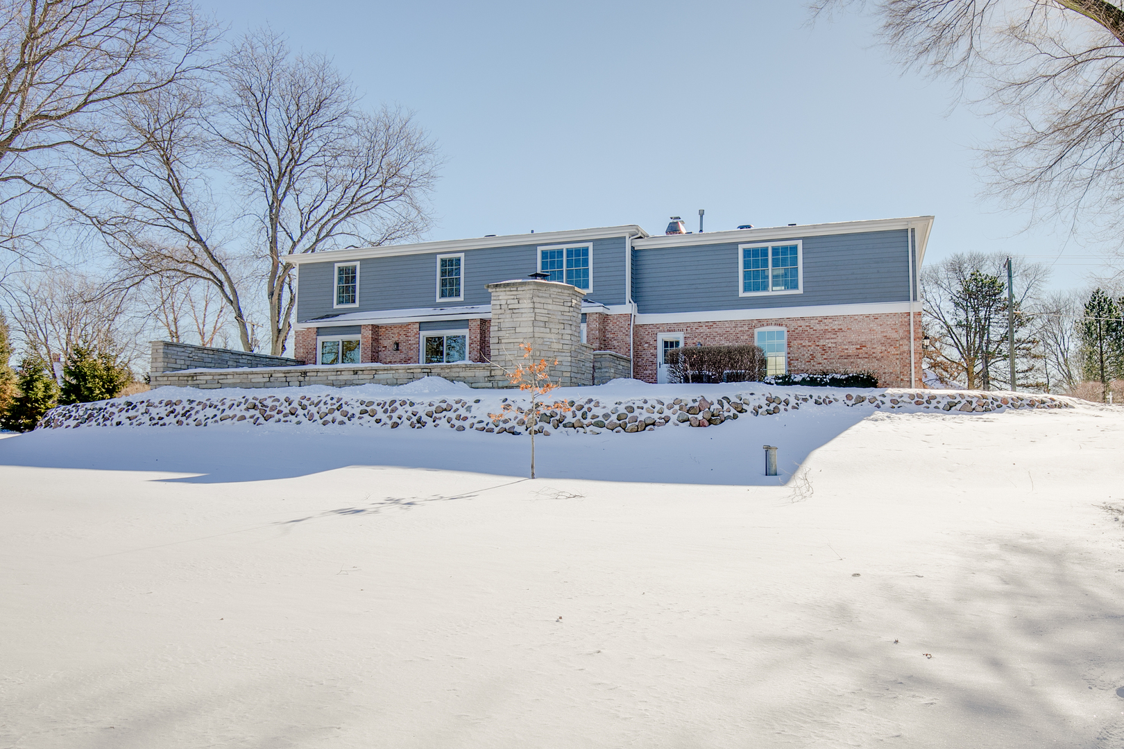 21242 West Long Grove Road Kildeer, IL 60047 - Photo 40 of 42 a front view of a house with a yard covered in snow