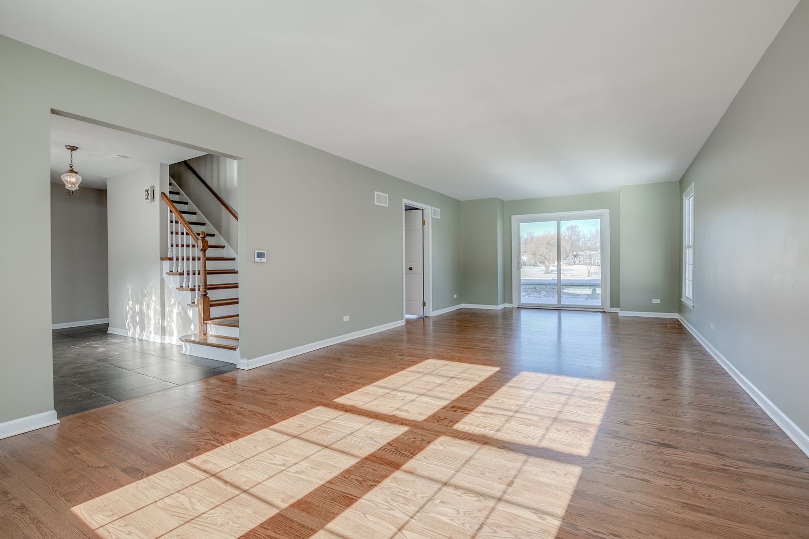 21242 West Long Grove Road Kildeer, IL 60047 - Photo 7 of 42 a view of a room with stairs and wooden floor