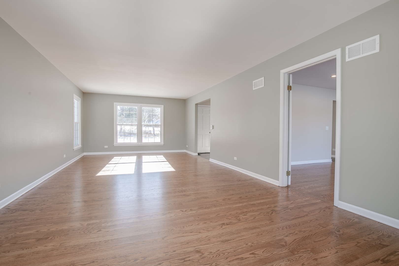 21242 West Long Grove Road Kildeer, IL 60047 - Photo 8 of 42 an empty room with wooden floor and windows