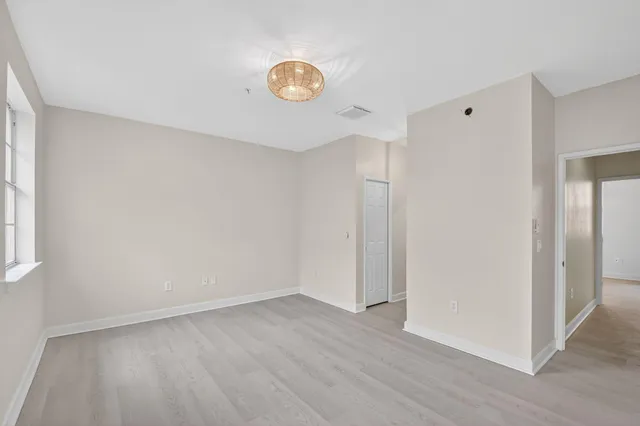 a view of a room with wooden floor