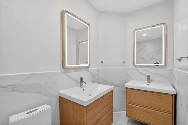 a bathroom with a sink toilet a vanity and mirror