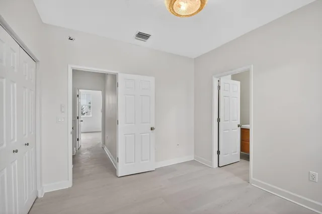 an empty room with closet and window