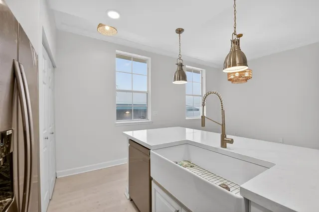 a kitchen with stainless steel appliances granite countertop a sink and a refrigerator
