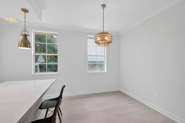 a view of a room that has a window and furniture