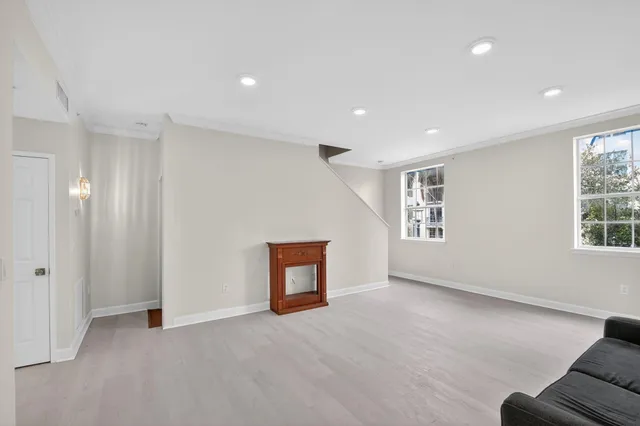 an empty room with windows and closet