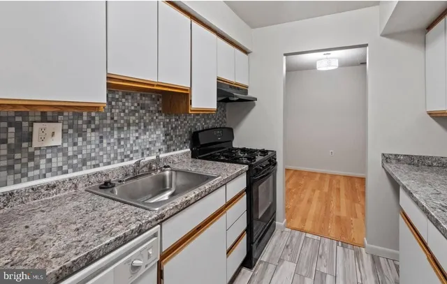 a kitchen with a sink and cabinets
