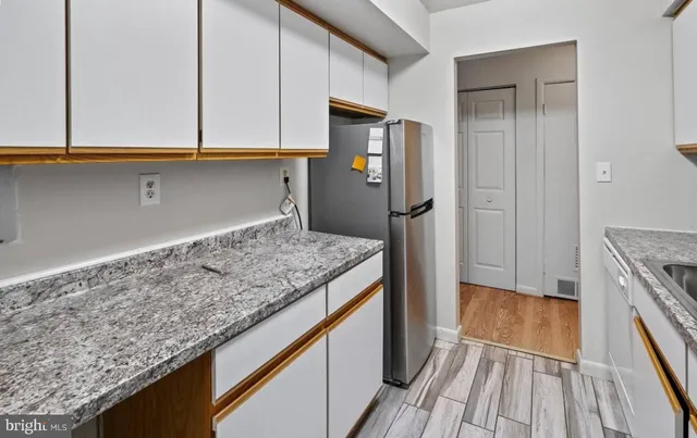 a kitchen with kitchen island granite countertop a stove and a refrigerator