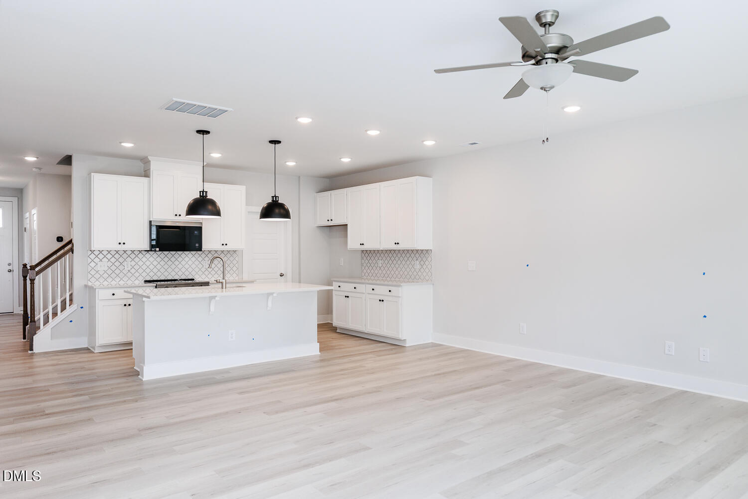 35 Silver Pne Drive Angier, NC 27501 - Photo 11 of 41 an open kitchen with kitchen island white cabinets and stainless steel appliances